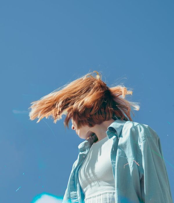Woman feeling energetic and vibrant in a bright, open space.